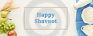 Top view image of dairy products and fruits on wooden background. Symbols of jewish holiday - Shavuot.