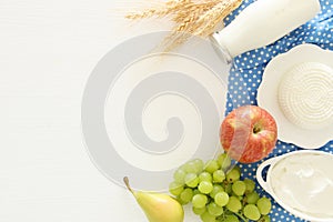 Top view image of dairy products and fruits on wooden background. Symbols of jewish holiday - Shavuot.