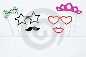 Top view image of funny and colorful photo booth props for party over white background.