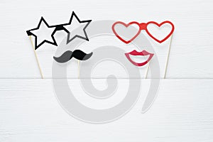 Top view image of funny and colorful photo booth props for party over white background.