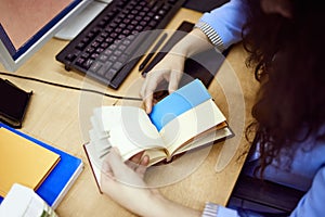 Top view image of graphic designer working with graphic tablet, using color palette, making sketches on computer