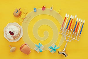 Top view image of jewish holiday Hanukkah background with traditional spinnig top, menorah & x28;traditional candelabra& x29;
