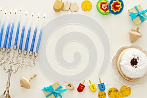 Top view image of jewish holiday Hanukkah background with traditional spinnig top, menorah & x28;traditional candelabra& x29;