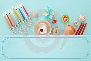 Top view image of jewish holiday Hanukkah background with traditional spinnig top, menorah (traditional candelabra)