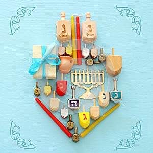 Top view image of jewish holiday Hanukkah background with traditional spinnig top, menorah (traditional candelabra) and candles.