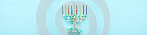 Top view image of jewish holiday Hanukkah background with traditional spinnig top, menorah (traditional candelabra) and candles.