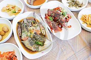 Top view image of Korean traditional cuisine on table, soy sauce marinated crab with a lot of side dishes