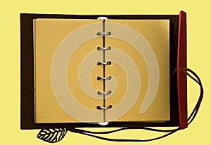 Top view image of open notebook with blank pages isolated on a yellow background, ready for adding text