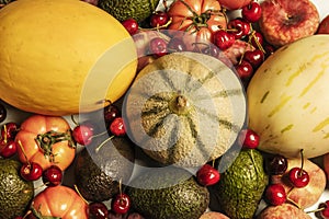 Top view image of a still life with ripe melons, picota cherries, various tomatoes, Canarian bananas photo
