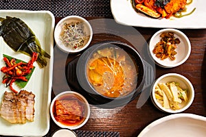 Top view image of Tofu stew and boiled pork meat at Korean traditional full course set meal with side dishes
