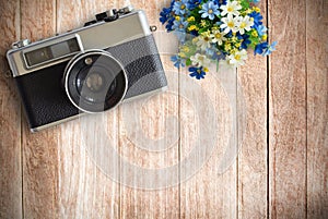Top view image of vintage old camera on wooden table background