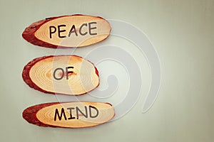 Top view image of wooden signs with the text peace of mind