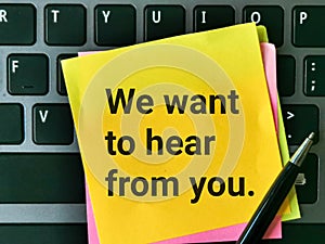 Top view image yellow sticky note written text we want to hear from you.