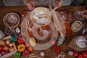 Top view images, a people preparing equipment and ingredients, flour, vegetables for making pizza