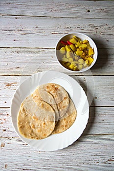 Top view of Indian breakfast paratha and sabzi in a plate