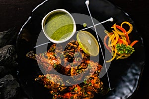 Top view of Indian style Roasted Chicken with lemon and Green sauce