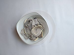 Top view of indonesian snack called KUPING GAJAH on the bowl,  white background