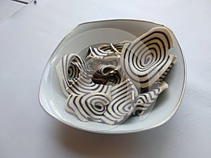 Top view of indonesian snack called KUPING GAJAH on the bowl,  white background