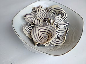 Top view of indonesian snack called KUPING GAJAH on the bowl,  white background