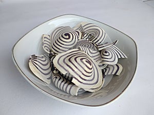 Top view of indonesian snack called KUPING GAJAH on the bowl,  white background