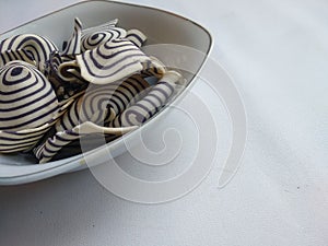 Top view of indonesian snack called KUPING GAJAH on the bowl,  white background