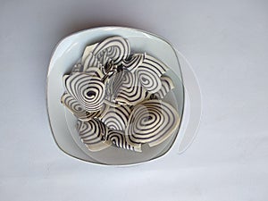 Top view of indonesian snack called KUPING GAJAH on the bowl,  white background