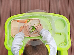 Top view of infant baby eating by Baby Led Weaning BLW. Finger foods concept