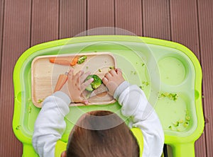 Top view of infant baby eating by Baby Led Weaning BLW. Finger foods concept photo