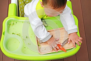 Top view of infant baby eating by Baby Led Weaning BLW. Finger foods concept