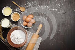 Top view of ingredients bakery making on black wooden table