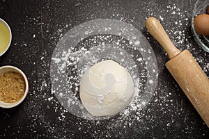 Top view of ingredients bakery making on black wooden table