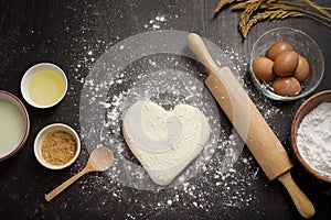 Top view of ingredients bakery making on black wooden table