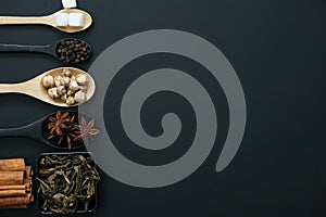 Top view of ingredients of masala chai or Indian spices tea on blackboard