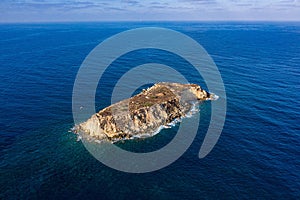 Top view of the inhabited Geronisos island surrounded by a blue seascape in Cyprus