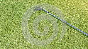Top view of iron golf club on the gold course grass
