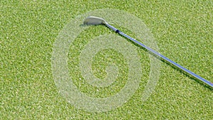 Top view of iron golf club on the gold course grass