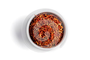 Isolated dried spice saffron in a white bowl