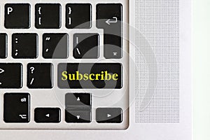 Top view isolated laptop keyboard with yellow `subscribe` text on button, concept design v