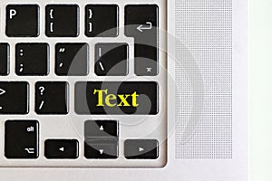Top view isolated laptop keyboard with yellow `text` text on button, concept design f