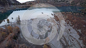 Top view of the Issyk mountain lake and the dam.