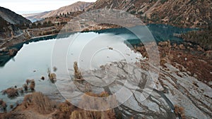 Top view of the Issyk mountain lake and the dam.