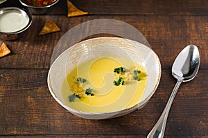 Top view of Italian corn soup on wooden table