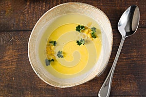 Top view of Italian corn soup on wooden table