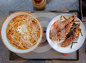 Top view, Japanese cusine, lunch set consists of hot soba noodles and Ten Don Shrimp Tempura on top of steamed rice Rice Bowl