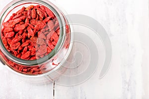 Top view of a jar filled with superfood goji berries
