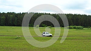 Top view of a jeep driving on a dirt road in nature