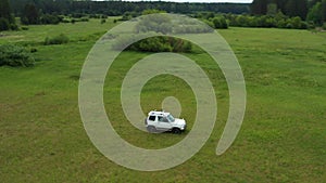 Top view of a jeep driving on a dirt road in nature