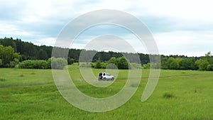 Top view of a jeep driving on a dirt road in nature