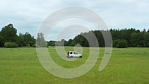 Top view of a jeep driving on a dirt road in nature