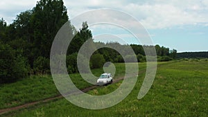 Top view of a jeep driving on a dirt road in nature